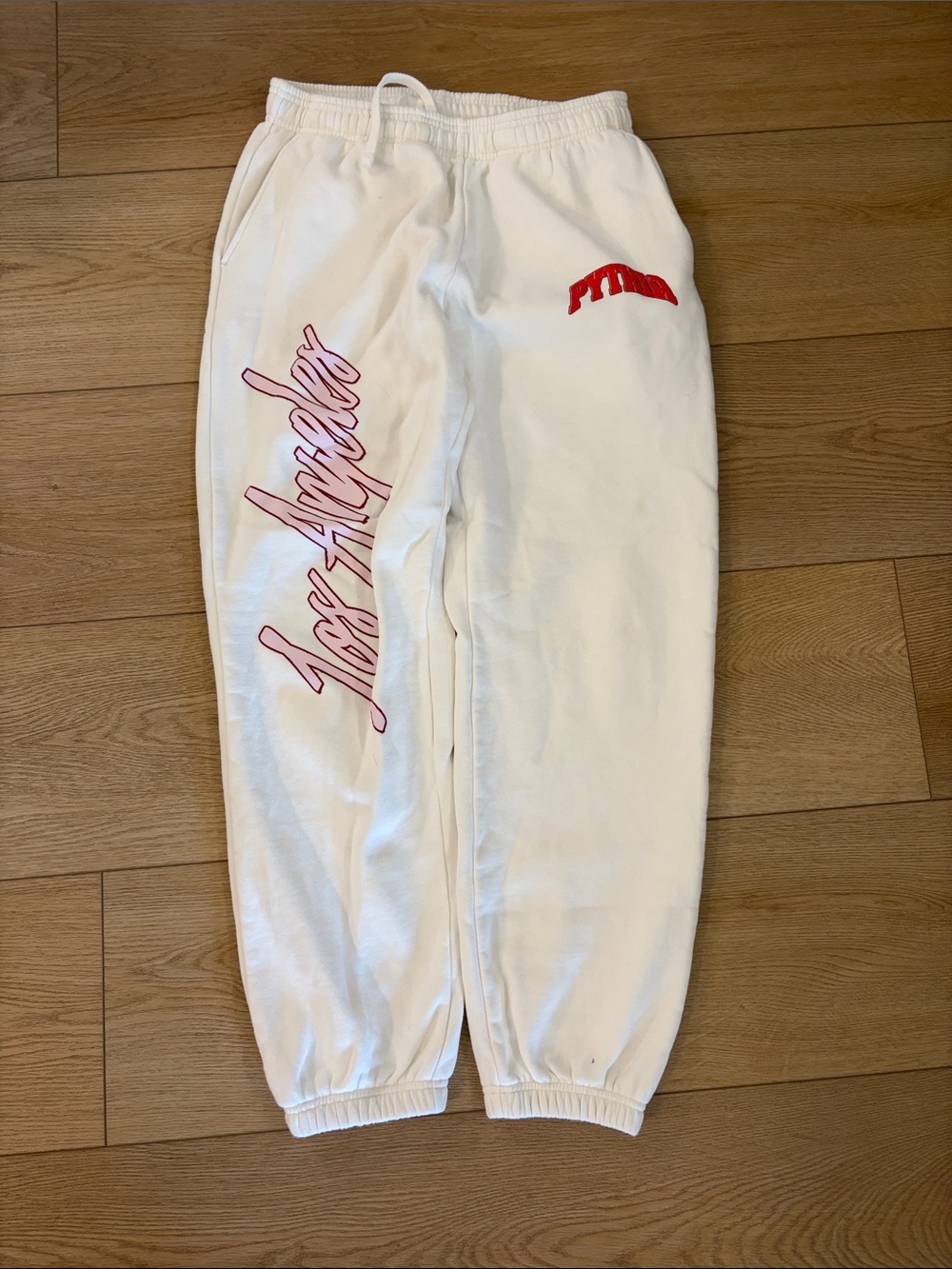 White Kids Joggers with Pink Script and Red Accent
